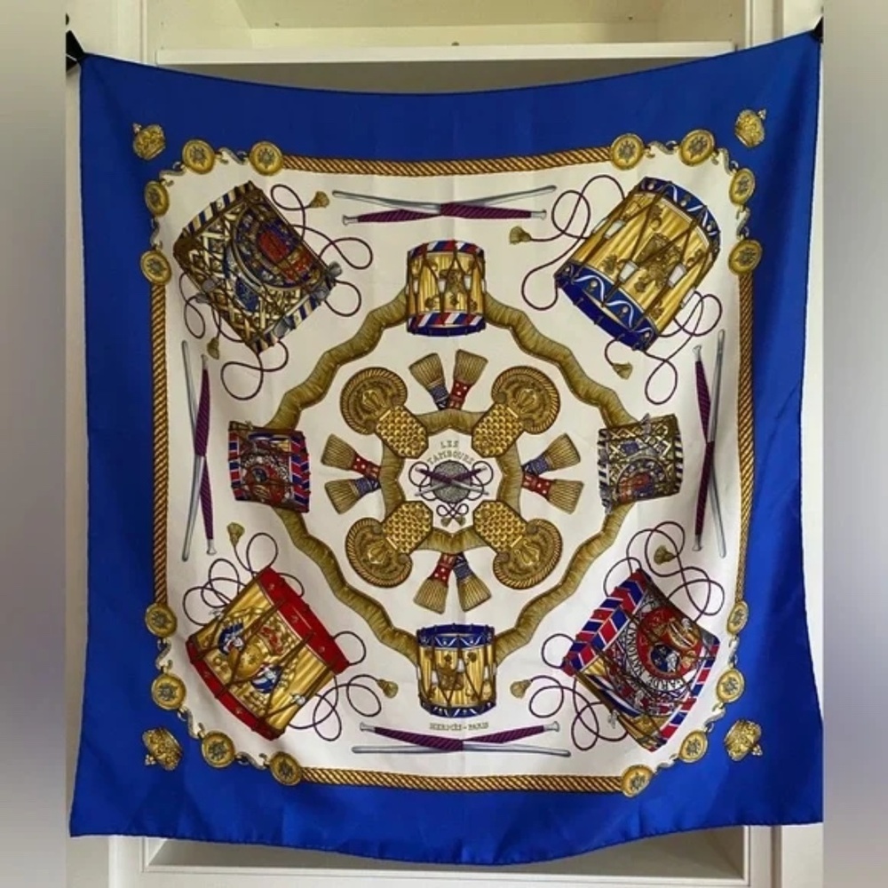 Hermes Les Tambours Silk Scarf in vibrant jewel tones, blues, reds and gold on a